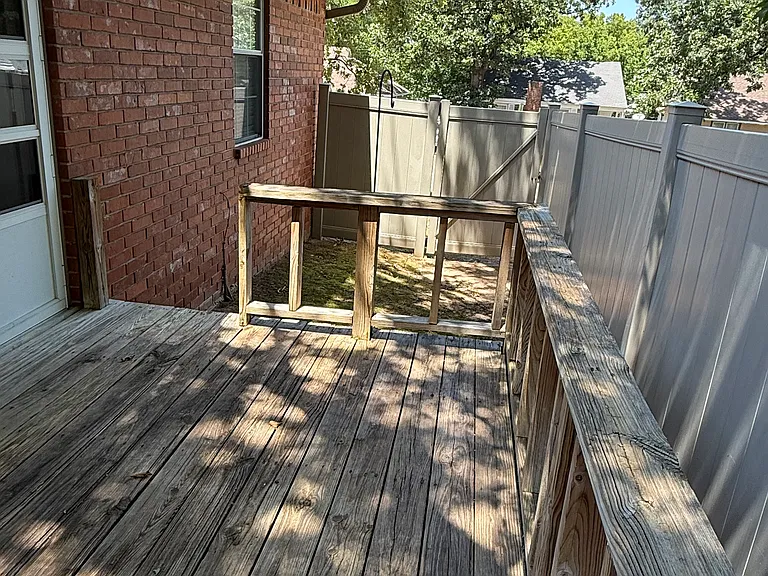 12 ft x 7.8 ft deck. with side gate and storm door with screened panels. PVC white privacy fence