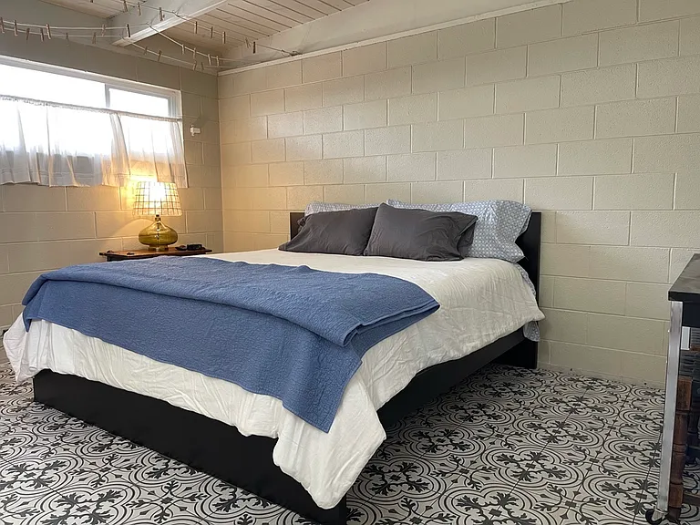 First bedroom with King sized bed. Tile floor, and its own heater/air-conditioner unit. Walk in closet, and desk. Linens are 100% cotton. Black out curtains (photo does not show them).