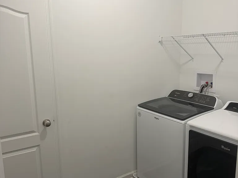 Laundry room with closet