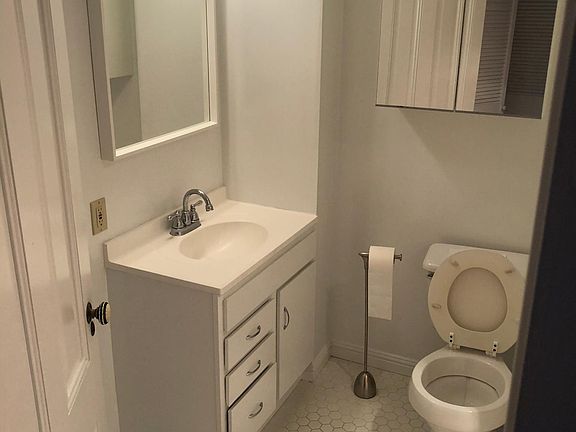 tiled bathroom (shower not pictured, to right)
