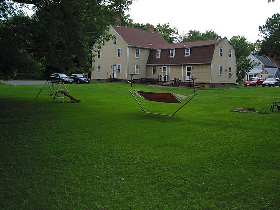 View across larger yard. The apartment's rear door if the rightmost door.