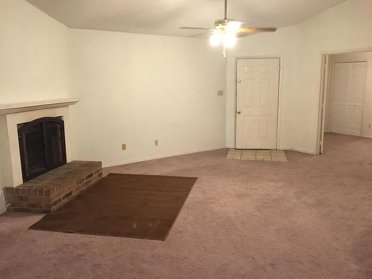 Living room with fireplace - has dark wood flooring now.