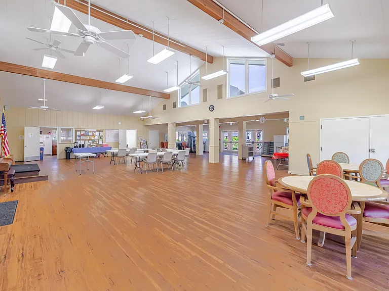 Spacious community room with flexible seating and abundant natural light perfect for gatherings.