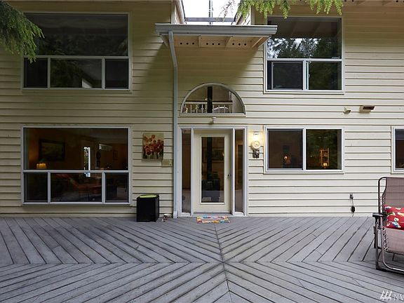 Rear view of home, HUGE entertaining deck, faces greenbelt. 