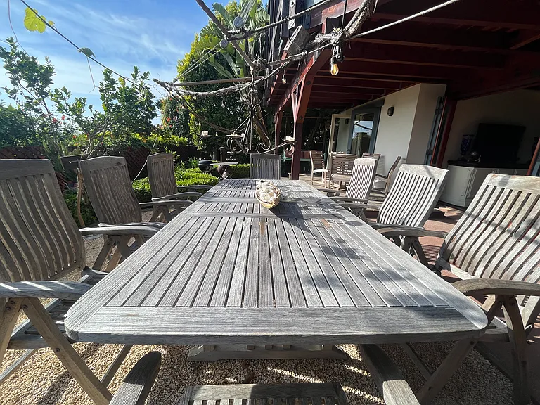 large teak table seats 8, under the grapevines in the summer months