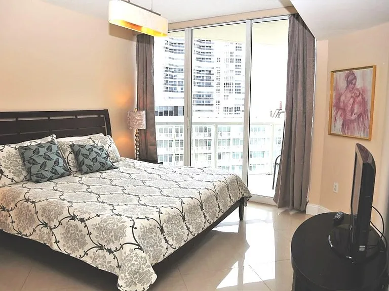 Master bedroom with king size bed and second TV.