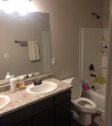 Guest bathroom with dual sinks and a full bath