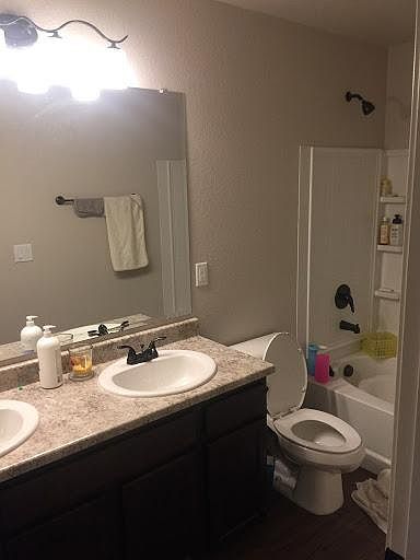 Guest bathroom with dual sinks and a full bath
