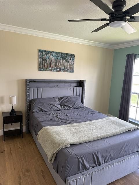 Queen bed with built in LED strip light and charging ports. Sheets, pillows and blanket