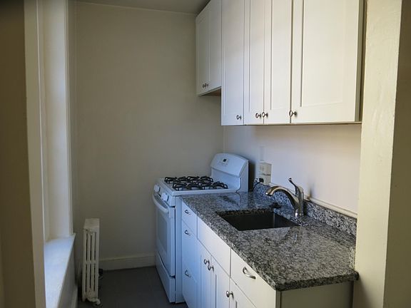 Kitchen from entrance to kitchen. The refrigerator is to the right outside the photo.
