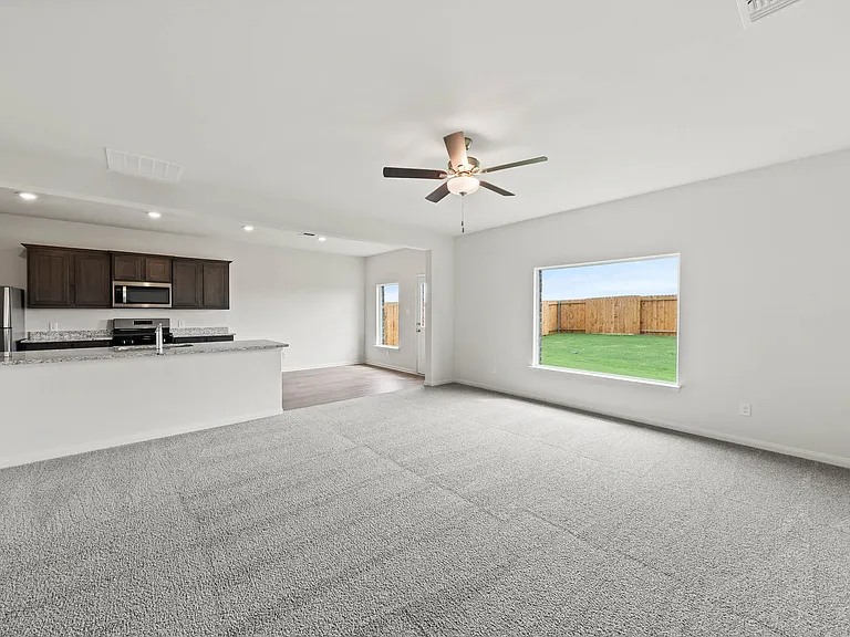 The open layout connects the kitchen with the dining room and family room.