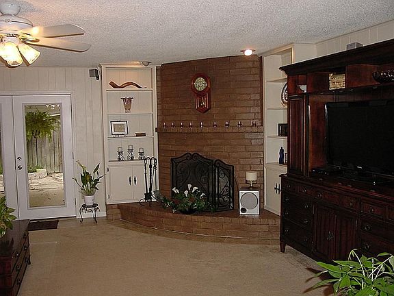 Den with Corner Fireplace and Built in Bookcases