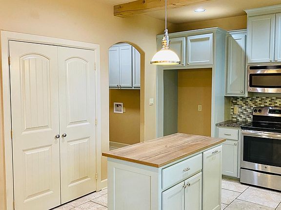 Kitchen showing double pantry and laundry room entrance