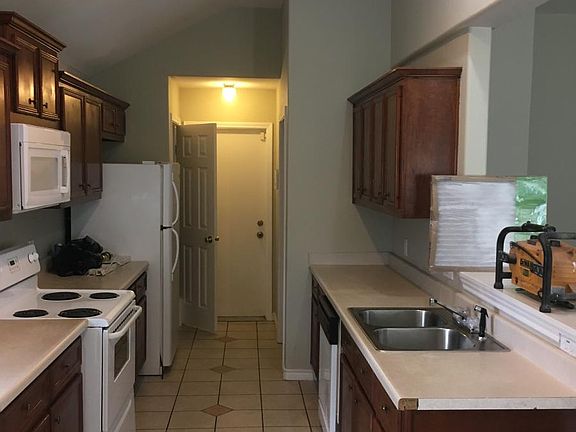 View of kitchen, looking towards door to the garage.