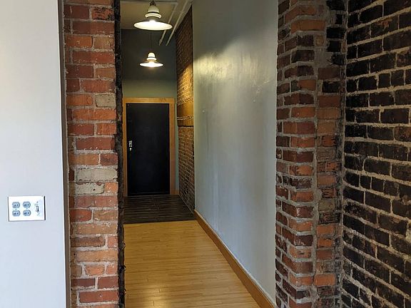 Exposed brick and hardwood floors.