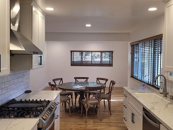 Updated kitchen with quartz counter tops, gas stove, free flowing into dining area and family room