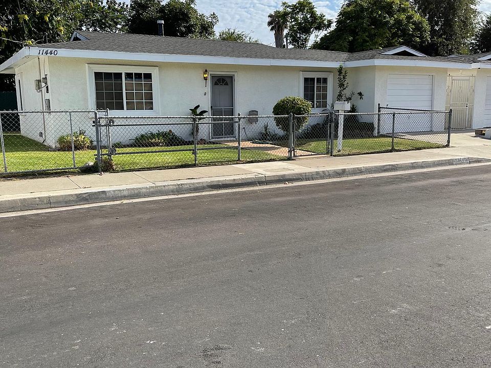 FRONT HOUSE SIDE AND BACK YARD WITH PATIO AND SINGLE CAR GARAGE AND SMALL DRIVEWAY PART OF A CORNER LOT