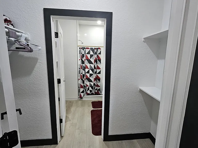 Bedroom 3 Walk in closet with easy-clean flooring for everyday convenience and access to ensuite bathroom.
