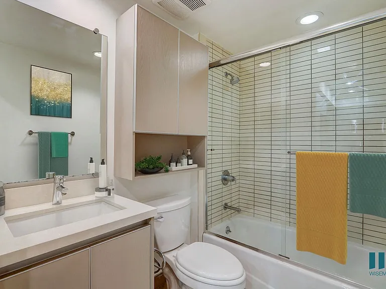 Bathroom with Shower-Bath with Glass Door and Cabinet Storage
