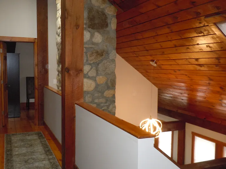 Vaulted ceilings with open hallway on second floor.