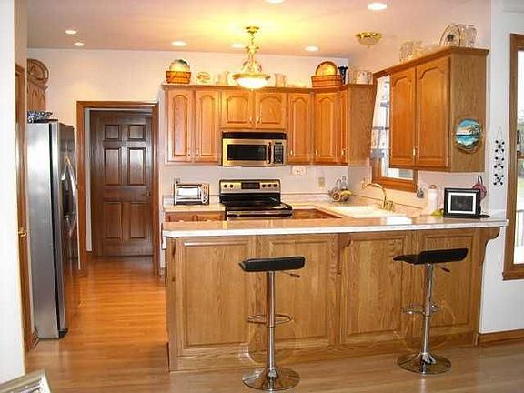 Kit. is loaded with custom cabinets, 2 walk-in pantries, all appl. stay.