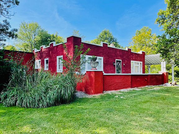 Secluded BBQ area to the left of the home over concrete pad.