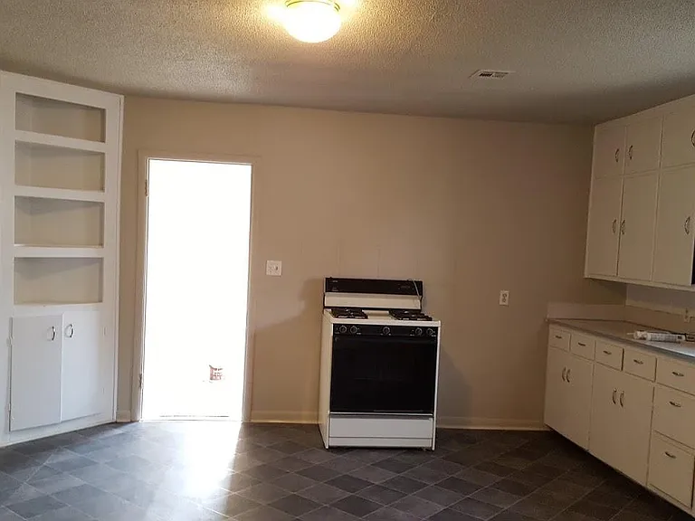 Kitchen w range and built in corner cabinet