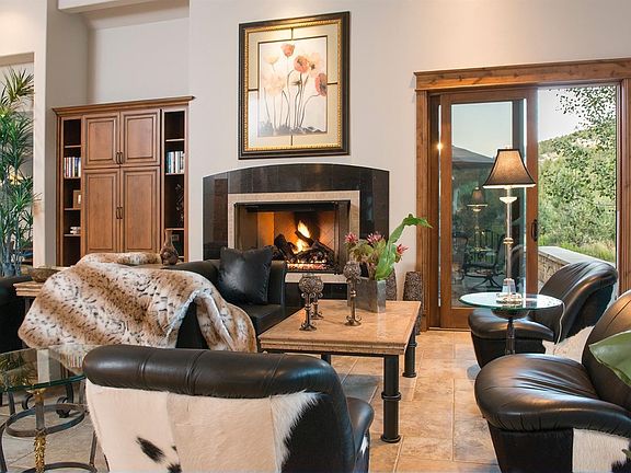 Another picture of the living room. Outside the sliding glass door is the large patio which also has a fireplace. Home is offered fully furnished.