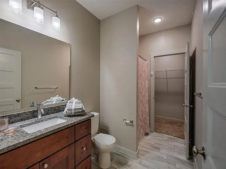 Modern bathroom with attached walk-in closet at Avenue 204.