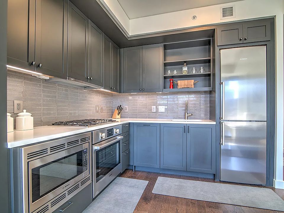 Kitchen includes refrigerator, gas stovetop, oven, microwave and dishwasher (aesthetically colored the same as the cabinets, next to sink)