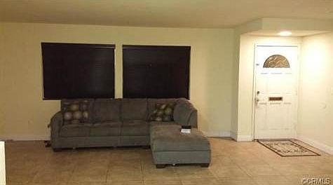 Main living room, new porcelain tile and window blinds!