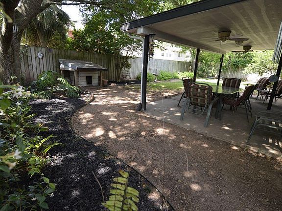 View of the expanded landscape beds and the size of the covered patio area