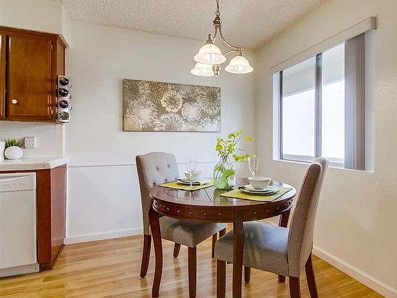 Dining area with large remotely controlled ceiling fan.