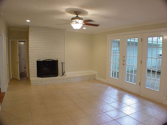 Den also has a wood burning fireplace.