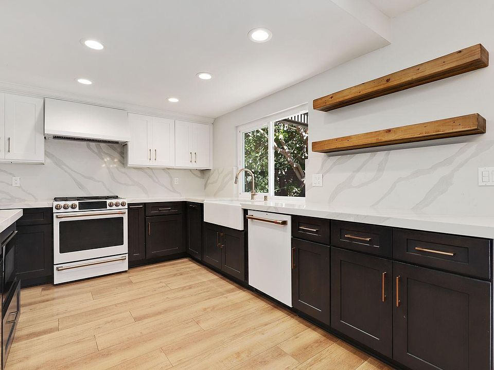 Fully updated kitchen with brand new Cafe appliances, brand new fridge with beverage center, floating shelves, pull out cabinets.