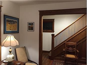 View of the original wood paneled floor, stairway, and raili