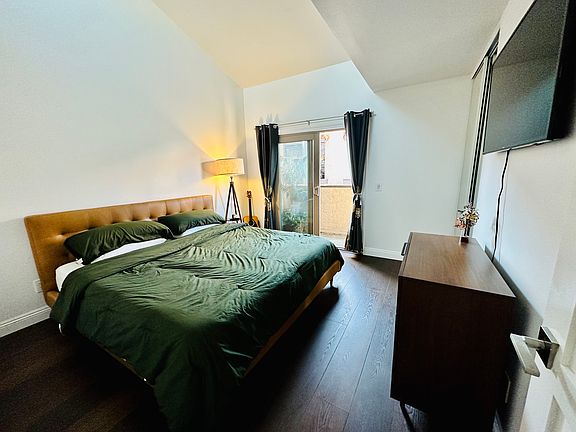 Primary bedroom with sky light and balcony that overlooks the fountain area. Closets have built in drawers and closet with full length mirrors.