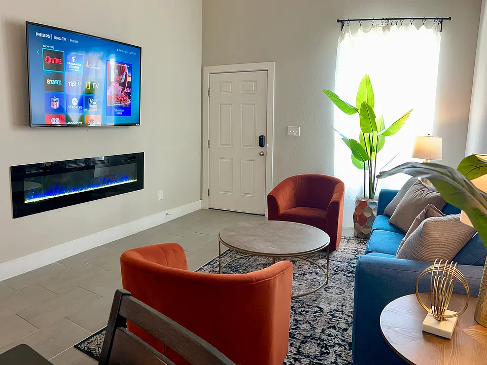 65" ROKU Smart TV in the living room, electric fireplace