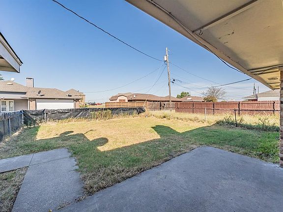 Fenced backyard with a patio