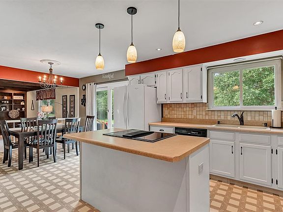 Spacious, open kitchen offers great lighting with lots of cabinet & counter space.
