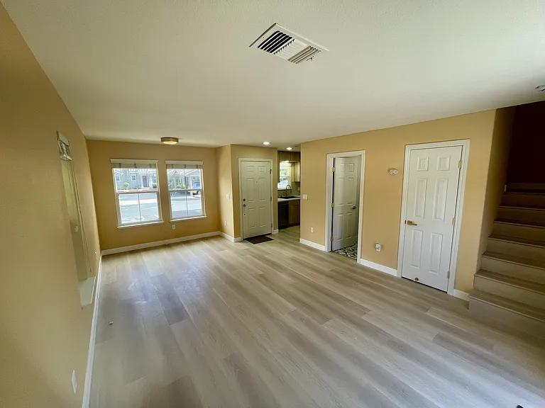 The living room on the first floor shows the entrance to the home.