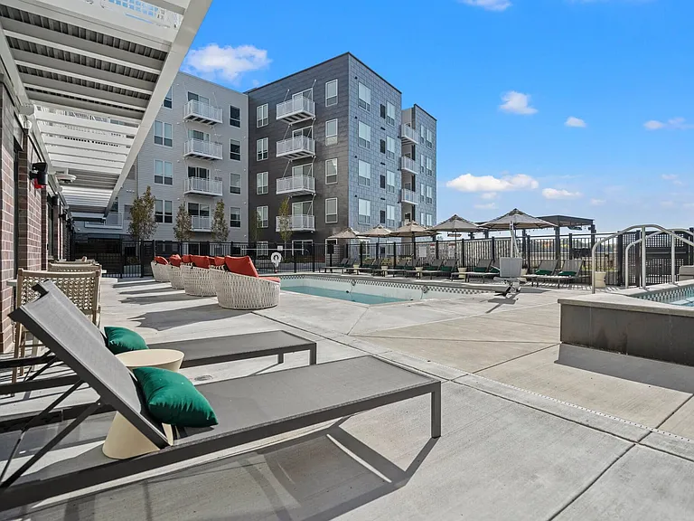 Sunbathe on our lounge chairs or take a dip in our pool or jacuzzi at The Hallon Luxury Apartments in Hopkins MN