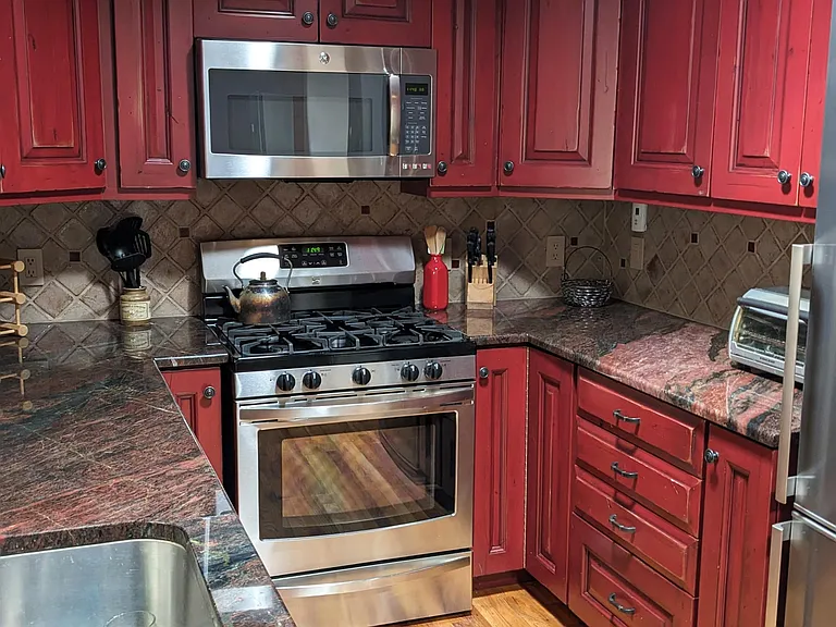 Rustic custom kitchen cabinets, Italian granite counters and brushed stainless appliances