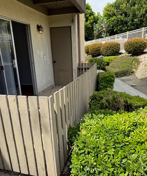 Tiled and fenced in patio with extra large storage closet