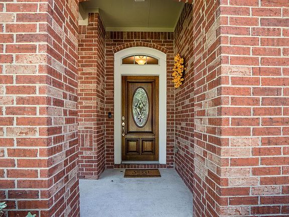 An invitation to enter this delightful home through a front covered porch.