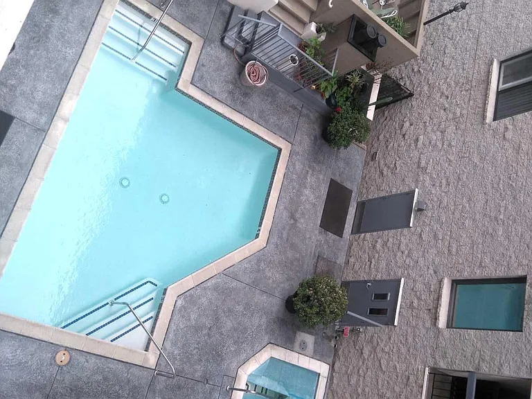 VIEW OF POOL AREA FROM 2ND BALCONY IN THE CONDO