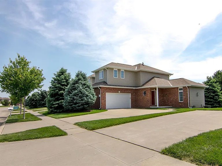 Step into a beautifully designed home with a charming blend of brick and siding, nestled in a serene neighborhood.