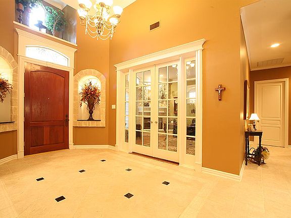 Beautiful Entryway flanked by study with custom french doors!!