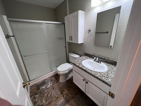 master bathroom with shower and cabinets