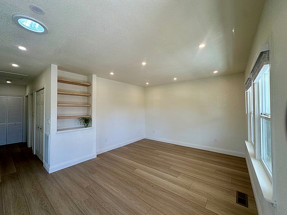 Bright and airy living room with built in shelving